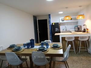 a room with a table and chairs and a kitchen at Toscana Suite 2 D in Estación El Salto