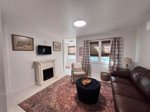 a living room with a couch and a fireplace at Belle Cottage in Eagle Rock