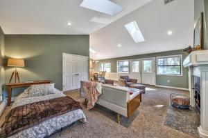 a bedroom with a bed and a couch and a fireplace at Minnow's Run in Brockway Vista