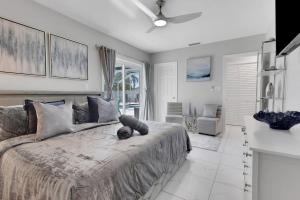 a bedroom with a large bed with a ceiling fan at Marco Island Pool, Spa Getaway Fenced Pet Friendly in Marco Island