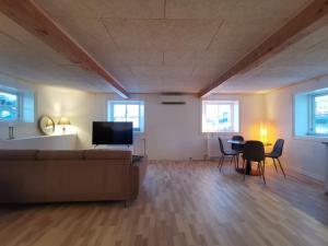 a living room with a couch and a table at Seperat lejlighed i stueetage in Sisimiut