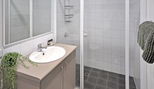 a bathroom with a sink and a shower at Stylish Studio 1x1 Walk to CBD in Port Hedland