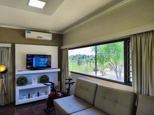 a living room with a couch and a large window at MIracampo in San Antonio de Arredondo