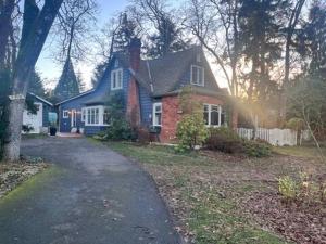 a house with a driveway in front of a house at Charming Victoria Character Home-Pet Friendly in Victoria