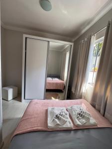 a bedroom with a bed and a large mirror at Casa de Praia in Penha