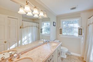 a bathroom with a sink and a toilet and a mirror at Private Pool and Home Theater Buchanan Family Home! in Buchanan +34 photos