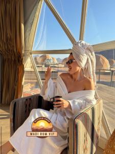 a woman sitting in a chair on a boat at WADI RUM NEOM lUXURY CAMP in Wadi Rum