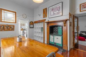 a living room with a wooden table and a fireplace at The Villa in Picton