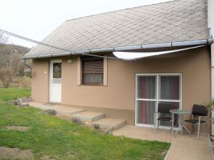a small house with a table and two chairs at Apartments in Balatongyörök 34590 in Balatongyörök