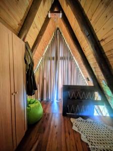 a room with a large window in a attic at Nova cabana com jacuzzi perto do mar in Arroio do Silva +22 photos