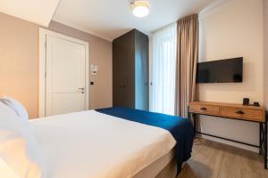 Postel nebo postele na pokoji v ubytování Invictus Hotel