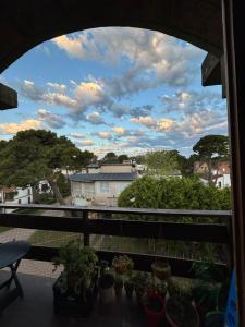 a view from a balcony with potted plants at aba casa estudio in Pinamar