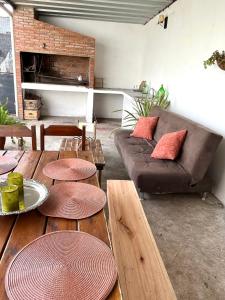 a living room with a couch and wooden tables at Casa, gran parrillero a pocos minutos de sitios turísticos in Minas