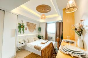 a bedroom with a bed and a dining table at Cozy Oak - Boho Studio for Couples with Huge Balcony in San Fernando +22 photos