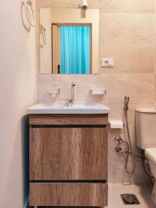 a bathroom with a sink and a mirror at maravilla downtown cairo in Cairo +56 photos