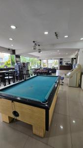 a pool table in the middle of a room at Monte Cervino Hotel in San Carlos de Bariloche +49 photos