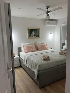 a bedroom with a bed and a ceiling fan at Apartments with parking space Mirca, Brac - 729 in Supetar
