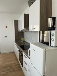 a kitchen with white appliances and wooden floors at Apartments with parking space Mirca, Brac - 729 in Supetar