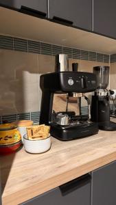 a black coffee maker sitting on top of a counter at Koala Cottage in Leongatha