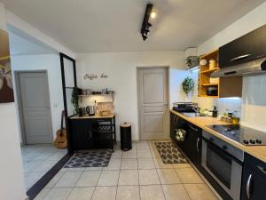 a kitchen with black cabinets and a counter top at Hinahei in Papeete