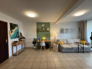 a living room with a couch and a table at Hinahei in Papeete