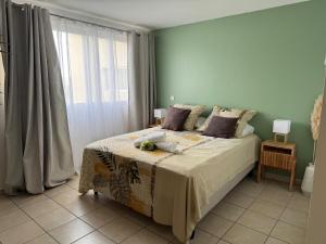 a bedroom with a bed and a large window at Hinahei in Papeete