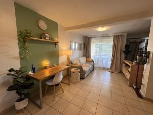 a living room with a table and a couch at Hinahei in Papeete