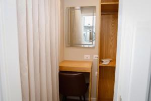 a room with a desk with a chair and a mirror at Hermes Petite Maison Hotel in Tirana +83 photos