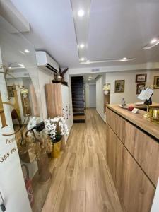 a room with a kitchen and a counter with flowers at Hermes Petite Maison Hotel in Tirana
