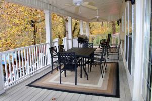 a porch with a table and chairs on it at Riverfront Retreat in Walland