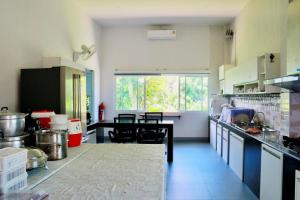 a large kitchen with a table and chairs in it at Lebest Pool Villa Chiang Mai in Ban Mai