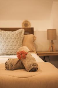 a towel with a bow sitting on top of a bed at Pahinga Villas Siargao in Libertad