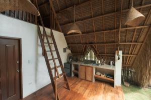 a kitchen with a ladder in a room at Pahinga Villas Siargao in Libertad