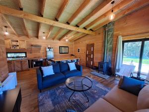 a living room with a couch and a table at Wehuilli Puelo in Cochamó