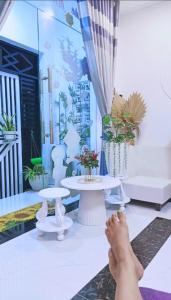 a person laying on the floor in a room with a table at Hoàng Nga 2 Homestay in Phan Thiet +37 photos