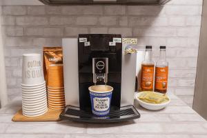 a coffee maker sitting on top of a counter at Tropical style room in Geusthouse in New York +7 photos