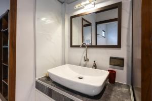 a white sink in a bathroom with a mirror at Bang Po Hut in Ban Bang Po +39 photos