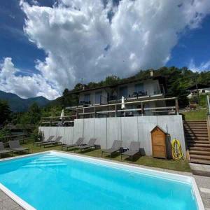 a large swimming pool in front of a house at Apartments in Pur - Ledrosee 22640 in Pur