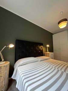 a bedroom with a large bed with a black headboard at Apartments in Pur - Ledrosee 22640 in Pur +42 photos