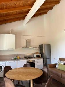 a kitchen with a table and a kitchen with a couch at Apartments in Pur - Ledrosee 22640 in Pur