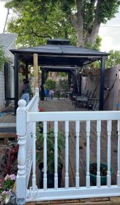 a gazebo on a deck with a white railing at Cherry Berry Niagara Falls in Niagara Falls