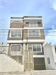 a brick building with a staircase and a door at Apto 101 - Acogedor, cómodo y óptimo - Casa Orquídeas in Fusagasuga