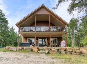 ein Haus mit Blick auf die Vorderseite in der Unterkunft Chalet COEUR de loup avec spa in Saint-Alexis-des-Monts