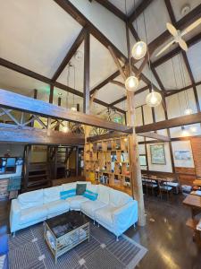 a large living room with a couch and a loft at Santana Lodge Hakuba in Hakuba