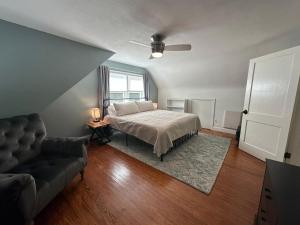 a bedroom with a bed and a couch and a window at Tranquil Hideaway For 4 Close To Annapolis in Annapolis