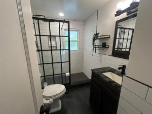 a bathroom with a shower and a toilet and a sink at Tranquil Hideaway For 4 Close To Annapolis in Annapolis +24 photos