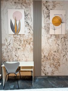 a desk and a chair in front of a wall at Hotel baramar moca in Moca
