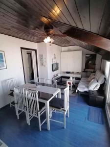a dining room with a table and chairs and a couch at Apartment in Crikvenica 53539 in Sopaljska