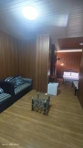 a room with two beds and a piano in it at Kiyomi's Inn in Baguio