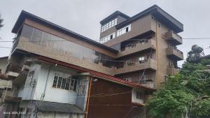 a large brick building with a large window at Kiyomi's Inn in Baguio